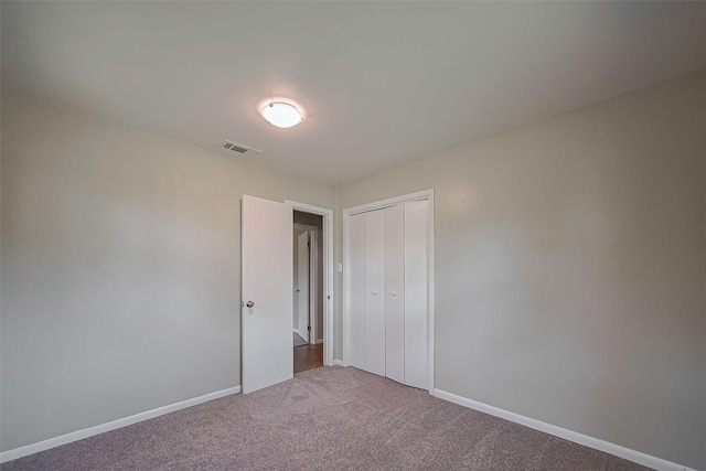111 N 11th St, Highlands, TX 77562 - unfurnished bedroom featuring carpet, baseboards, and a closet