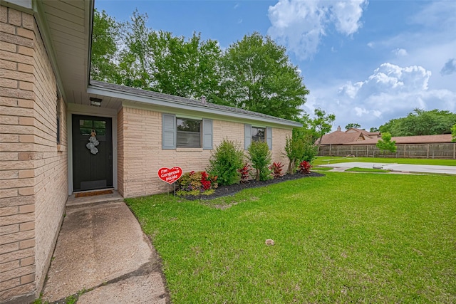 111 N 11th St, Highlands, TX 77562 - doorway to property with brick siding