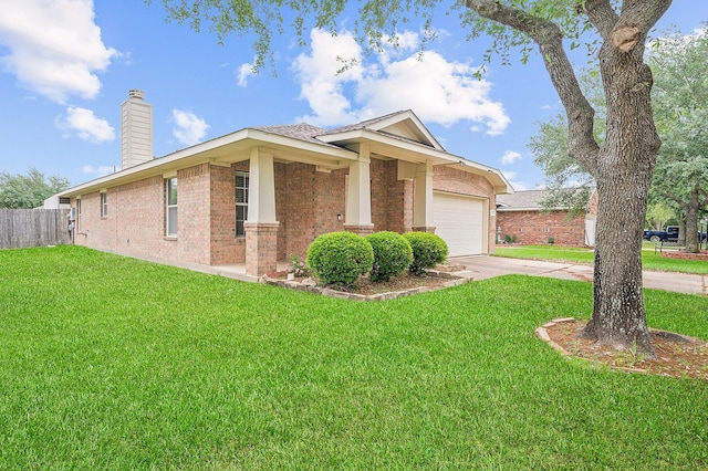 view of front of house with driveway, brick siding, a front yard, and a garage