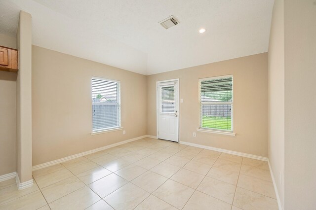 empty room with recessed lighting, baseboards, visible vents, and light tile patterned floors