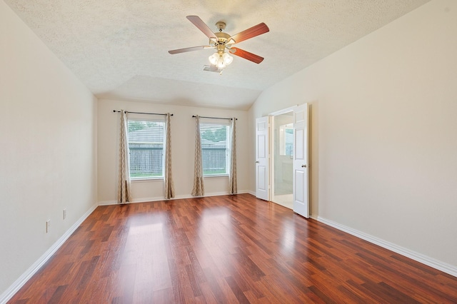 empty room featuring visible vents, a ceiling fan, wood finished floors, and a textured ceiling