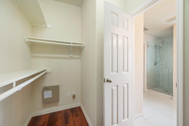 spacious closet with wood finished floors and visible vents