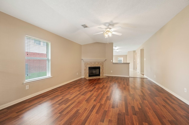 unfurnished living room with a ceiling fan, dark wood-style flooring, and plenty of natural light