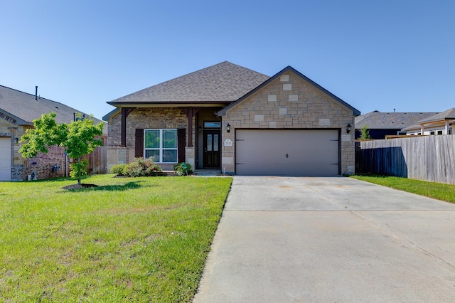view of front of house featuring fence, a front yard, roof with shingles, concrete driveway, and an attached garage