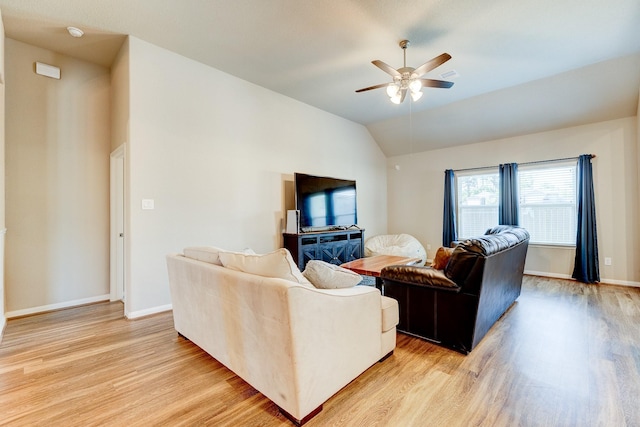 living room featuring ceiling fan, light wood finished floors, and lofted ceiling