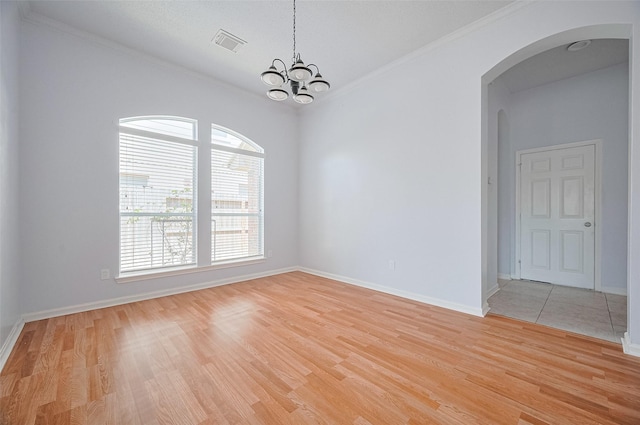 19915 Hardsville Dr, Spring, TX 77388 - spare room with arched walkways, light wood-type flooring, ornamental molding, a chandelier, and baseboards