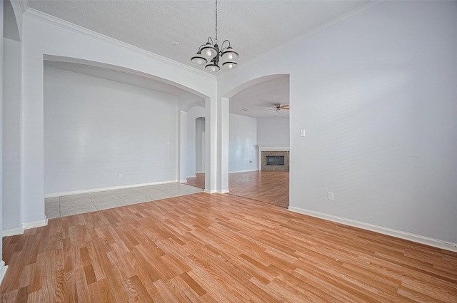 19915 Hardsville Dr, Spring, TX 77388 - unfurnished room featuring arched walkways, light wood finished floors, a ceiling fan, ornamental molding, and a chandelier