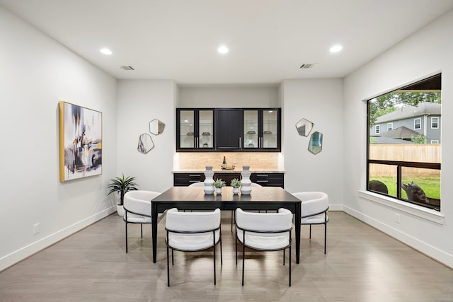 dining space featuring recessed lighting, light wood-type flooring, and visible vents