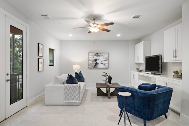 living area featuring a ceiling fan, visible vents, light carpet, and recessed lighting