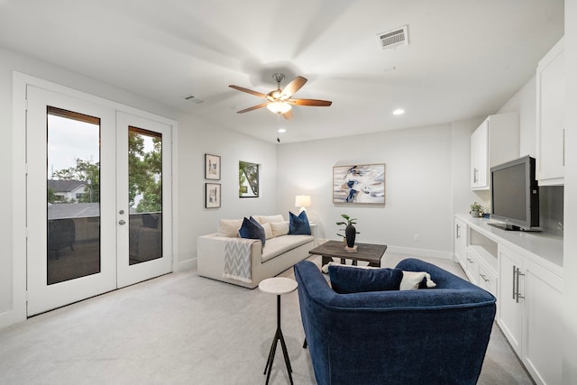 living room with visible vents, recessed lighting, a ceiling fan, and light carpet