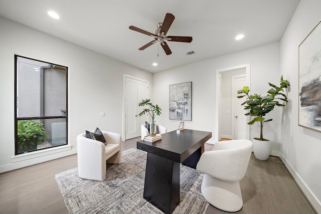 office featuring ceiling fan, recessed lighting, baseboards, wood finished floors, and visible vents
