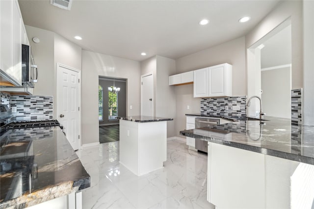 kitchen with tasteful backsplash, visible vents, appliances with stainless steel finishes, recessed lighting, and dark stone counters