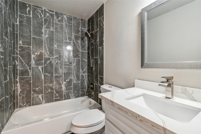 bathroom with toilet, vanity, a textured wall, and shower / bathtub combination