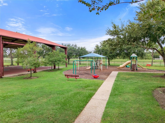 community play area featuring a lawn
