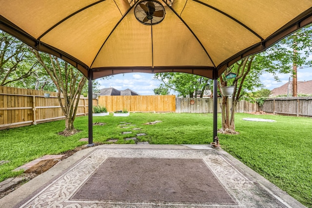 view of yard featuring a patio area, a fenced backyard, and a gazebo