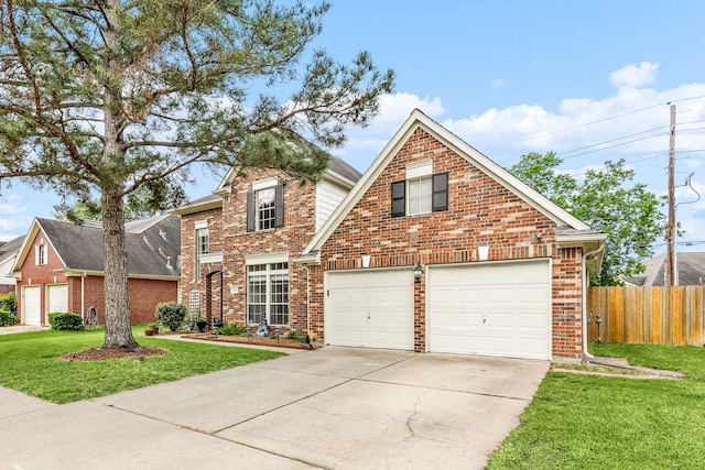 traditional-style home with a front lawn, driveway, fence, a garage, and brick siding