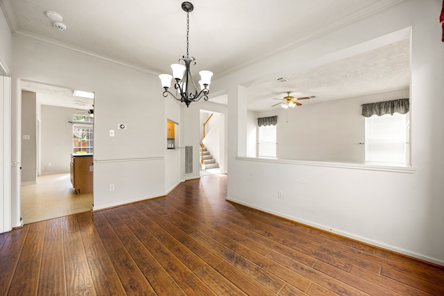 empty room with ceiling fan with notable chandelier, stairs, ornamental molding, and wood-type flooring