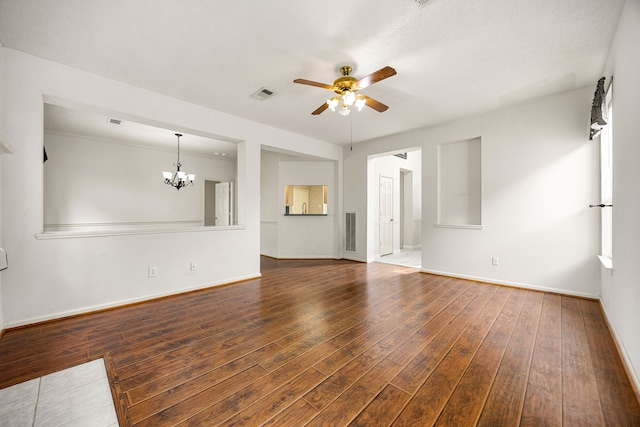 unfurnished living room with ceiling fan with notable chandelier, baseboards, hardwood / wood-style flooring, and visible vents