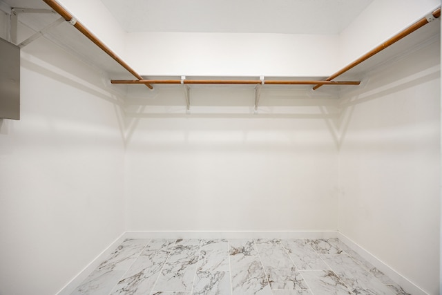 spacious closet featuring marble finish floor