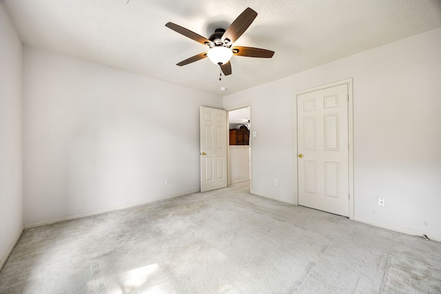 unfurnished bedroom with baseboards, carpet floors, and ceiling fan