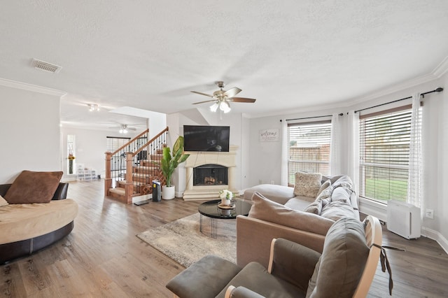 14942 Gray Ridge Dr, Houston, TX 77082 - living area featuring ornamental molding, a ceiling fan, visible vents, and a textured ceiling