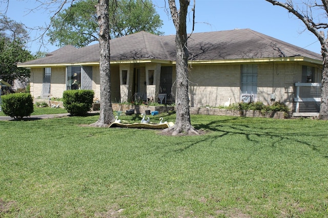 ranch-style home featuring brick siding and a front yard