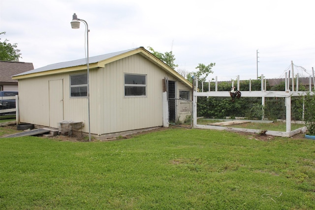 view of outbuilding with fence