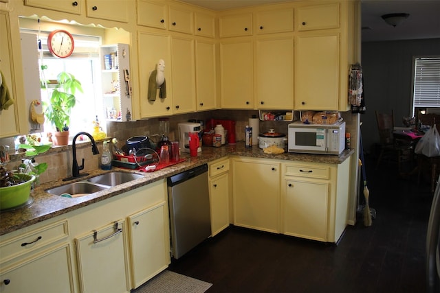 kitchen with tasteful backsplash, a sink, dishwasher, white microwave, and dark wood finished floors
