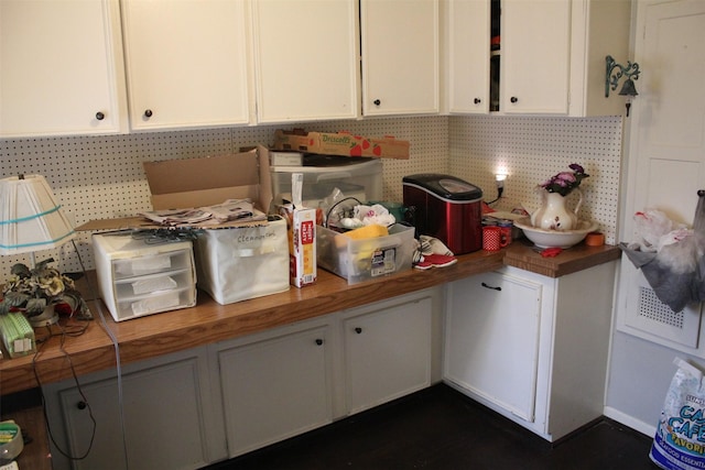 kitchen with white cabinets and butcher block counters