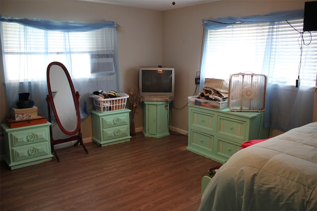 bedroom featuring baseboards and dark wood-style flooring