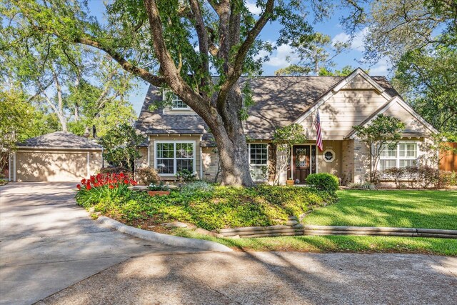 1302 Friarcreek Ln, Hilshire Village, TX 77055 - view of front of property with concrete driveway, a front lawn, and a garage