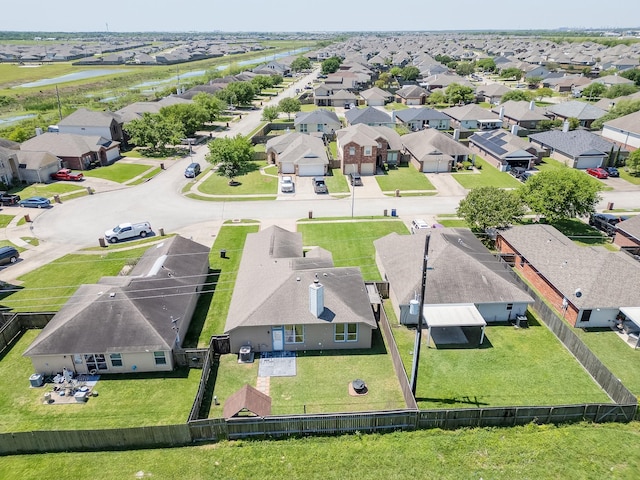 drone / aerial view featuring a residential view and a water view