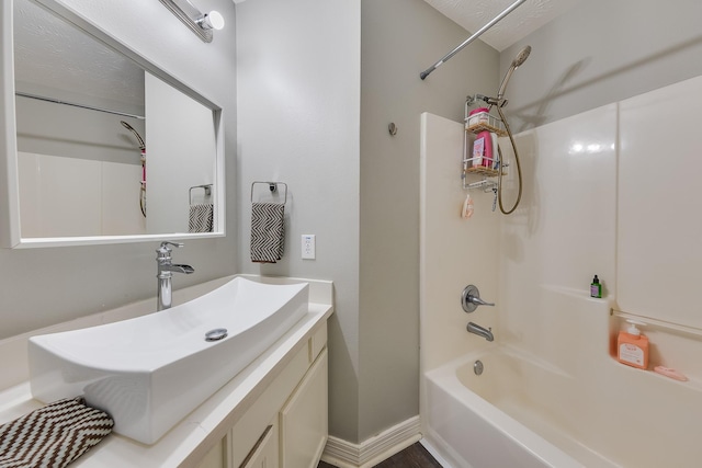 bathroom featuring vanity and  shower combination