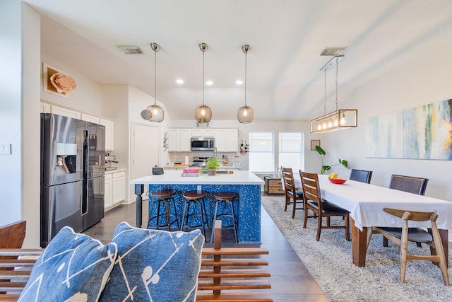 dining space featuring visible vents and recessed lighting