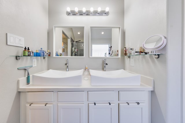 bathroom featuring a sink and double vanity