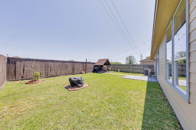 view of yard featuring central air condition unit and a fenced backyard