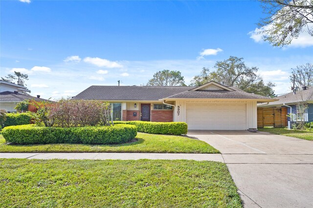 5307 Carew St, Houston, TX 77096 - ranch-style home featuring an attached garage, driveway, and board and batten siding