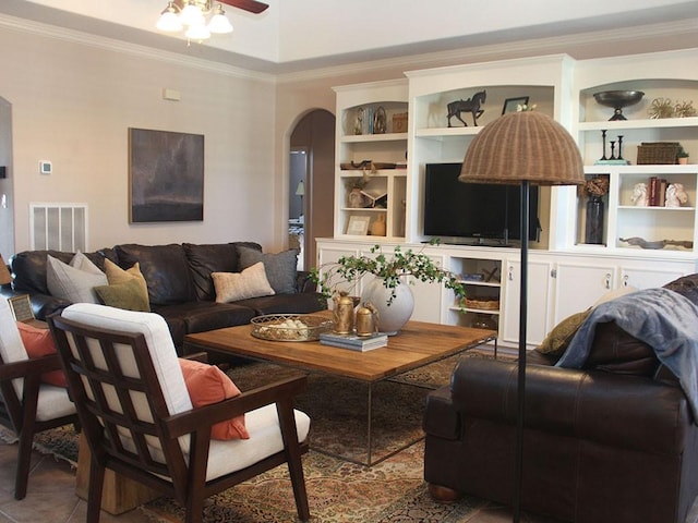 living area featuring arched walkways, ornamental molding, ceiling fan, and visible vents