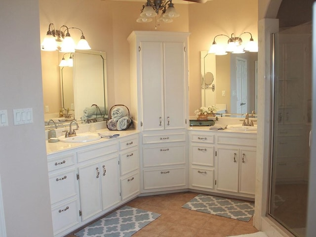 full bath with vanity, tile patterned floors, and an inviting chandelier