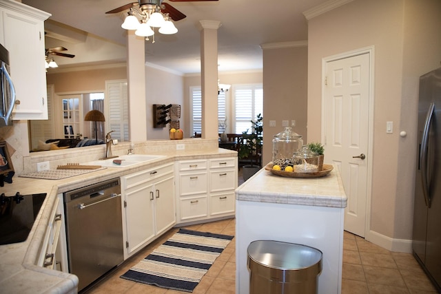 kitchen with appliances with stainless steel finishes, a sink, ceiling fan, and light countertops