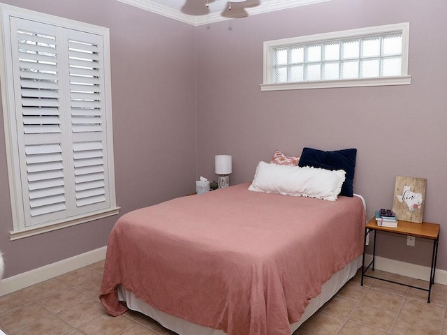 bedroom with crown molding, tile patterned floors, ceiling fan, and baseboards