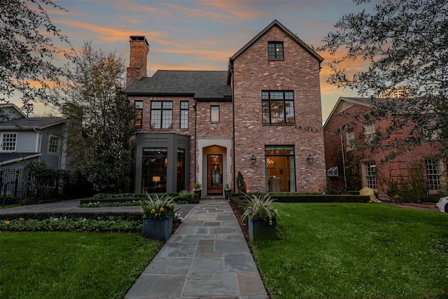 3028 Locke Ln, Houston, TX 77019 - view of front of property featuring a front lawn, brick siding, and a chimney