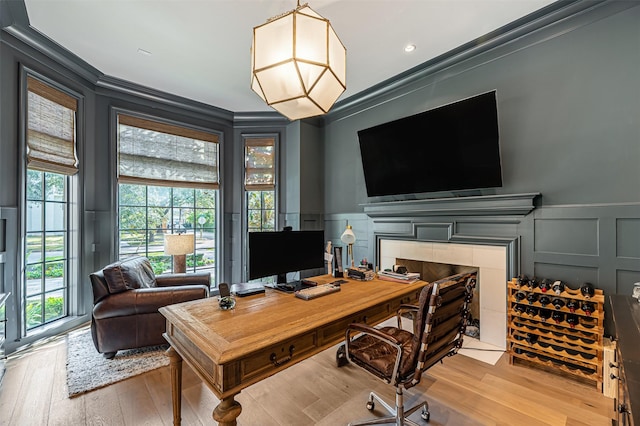 3028 Locke Ln, Houston, TX 77019 - office featuring crown molding, a decorative wall, wood finished floors, a wainscoted wall, and a tiled fireplace