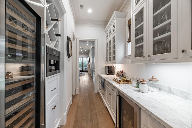 3028 Locke Ln, Houston, TX 77019 - bar with wine cooler, crown molding, light wood-style floors, and stainless steel microwave