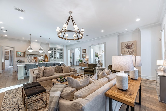 3028 Locke Ln, Houston, TX 77019 - living room with ornamental molding, a chandelier, recessed lighting, light wood-style flooring, and baseboards