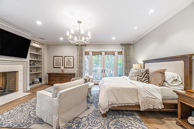 3028 Locke Ln, Houston, TX 77019 - bedroom with access to exterior, a chandelier, ornamental molding, wood finished floors, and recessed lighting