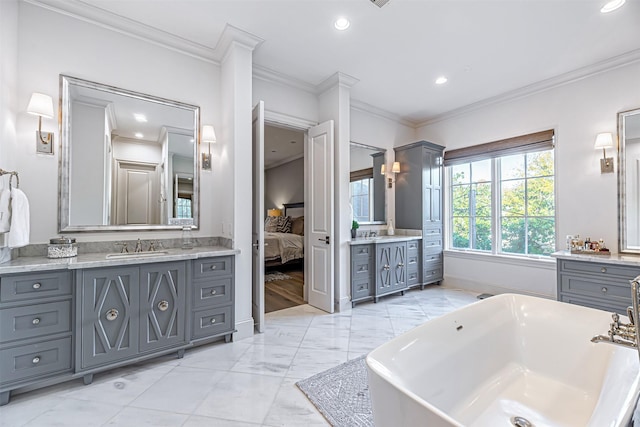 3028 Locke Ln, Houston, TX 77019 - bathroom featuring two vanities, a freestanding tub, connected bathroom, crown molding, and marble finish flooring