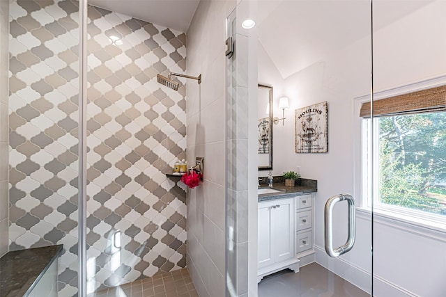 3028 Locke Ln, Houston, TX 77019 - full bath featuring vanity, a stall shower, vaulted ceiling, and tile patterned floors