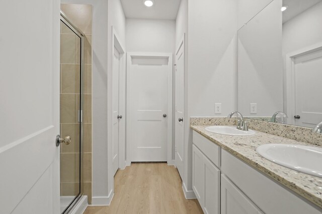 17824 Lionheart Rd, Conroe, TX 77306 - bathroom with a sink, wood finished floors, and a shower stall