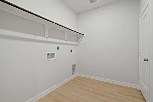17824 Lionheart Rd, Conroe, TX 77306 - clothes washing area with washer hookup, hookup for an electric dryer, laundry area, baseboards, and light wood-style flooring